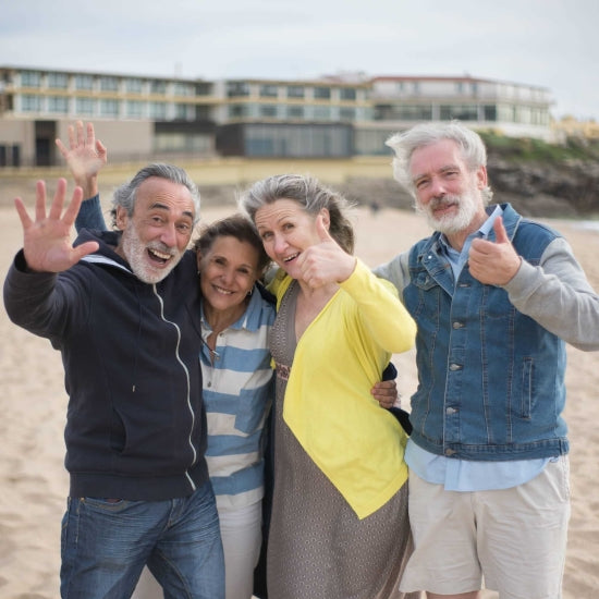 four seniors on the beach celebrating
